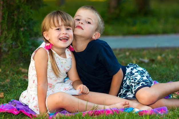 children sitting together on grass