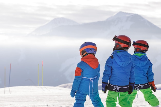 Children skiing and snowboarding in the mountains ski resort