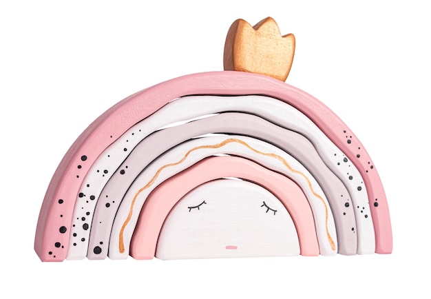 Children sleep concept Wooden rainbow stacking toy from arcs like princess with crown isolated on white background Beautiful eco gift for kids