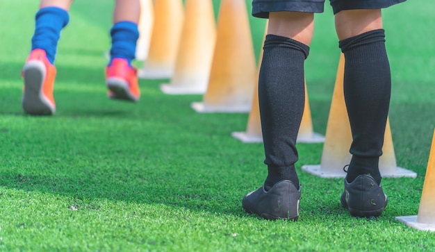 Children at soccer training on green outdoor soccer field