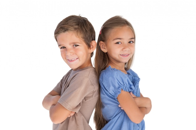 Children standing back to back with arms crossed