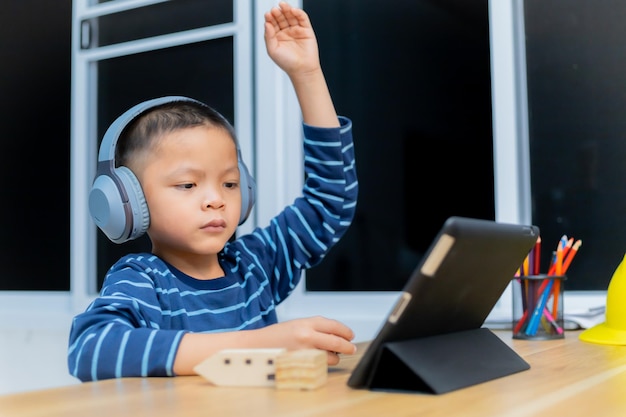 Children study online through tablets at home.