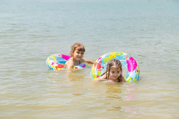 Children swimming in the lake.