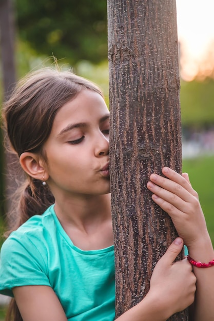 Children take care of nature tree in their hands Selective focus