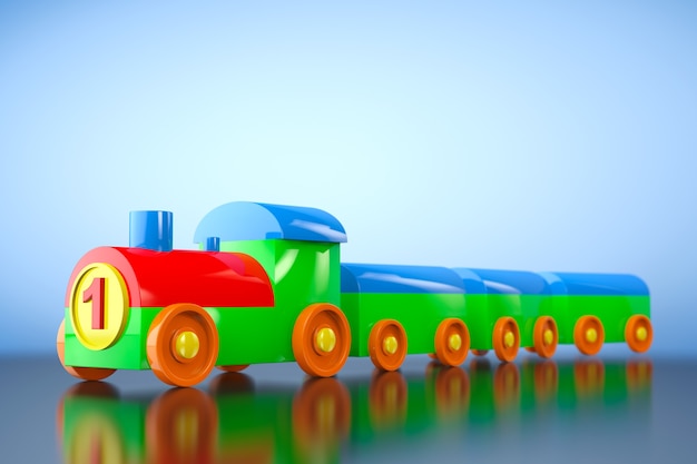 青い背景の上の子供のおもちゃの多色プラスチック列車。 3Dレンダリング