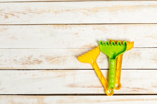 Children toys on wooden background, top view