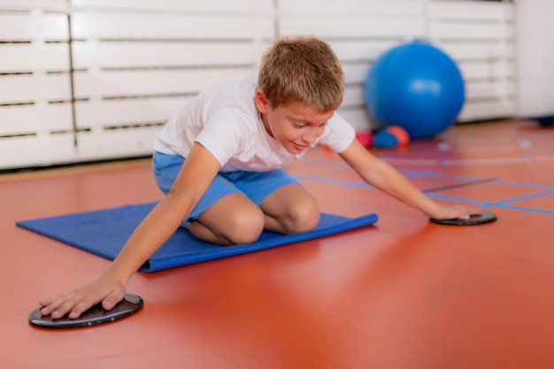 Children training with exercise gliders improving balance and coordination skills