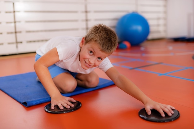 Children training with exercise gliders improving balance and coordination skills