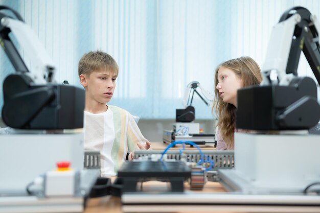 Children using the hand robot technology and having fun Learning the electronic circuit board