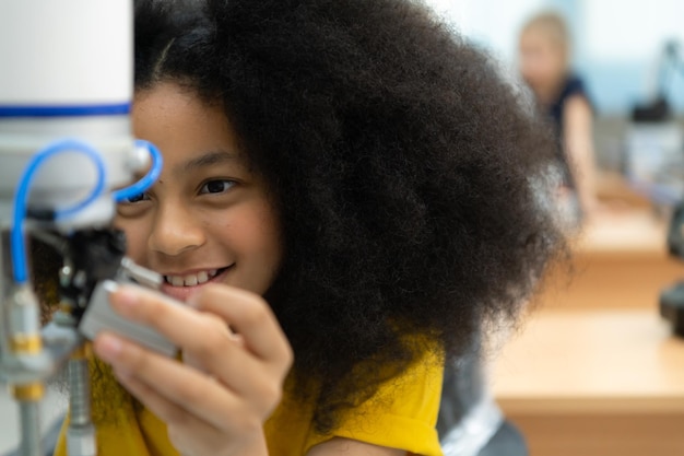 Photo children using the hand robot technology students are studying technology which is one of the stem