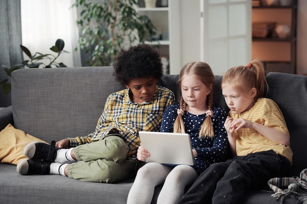 Children using tablet pc at home