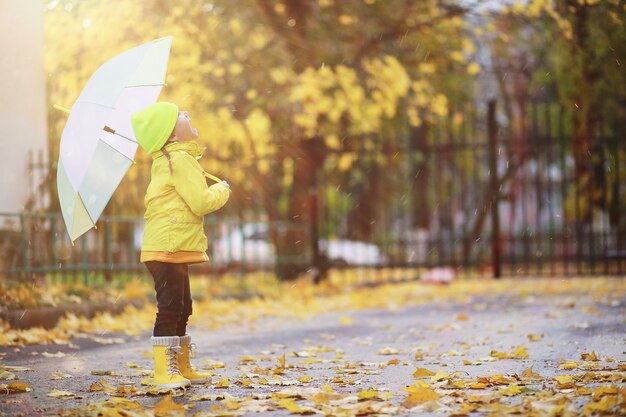 Children walk in the autumn park in the fall