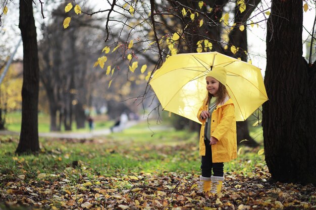 Children walk in the autumn park in the fall