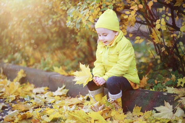 Children walk in the autumn park in the fall