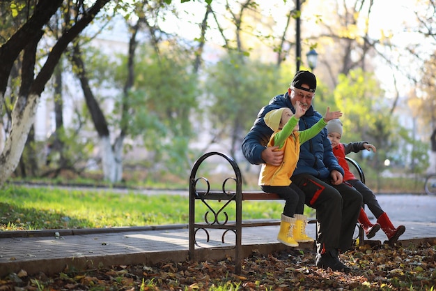 Children walk in the autumn park in the fall