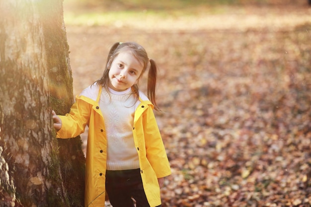 Children walk in the autumn park in the fall