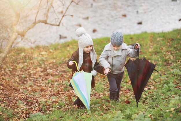 Children walk in the autumn park in the fall