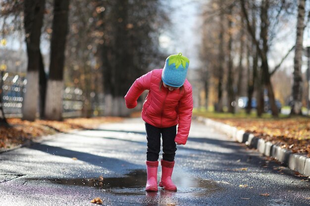 Children walk in the autumn park in the fall