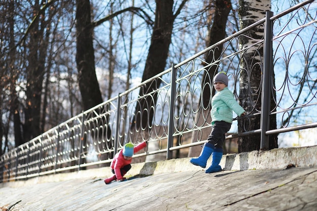 Children walk in the autumn park in the fall