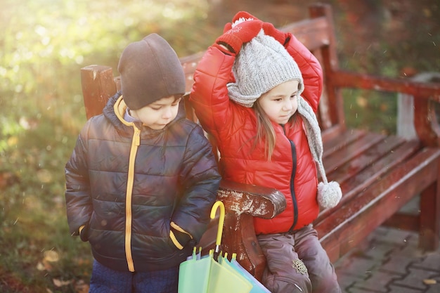 Children walk in the autumn park in the fall