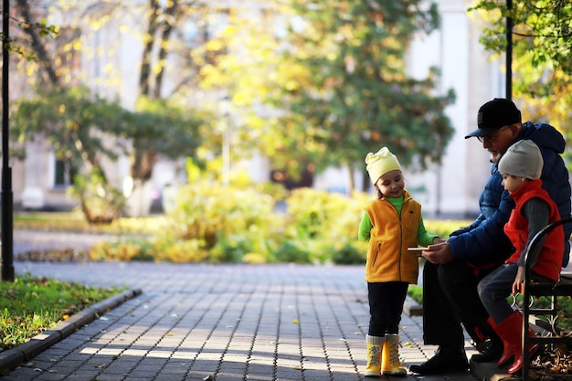 Children walk in the autumn park in the fall