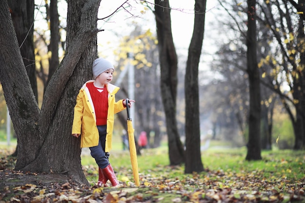 Children walk in the autumn park in the fall