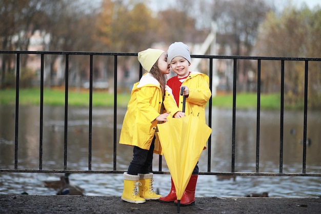 Children walk in the autumn park in the fall