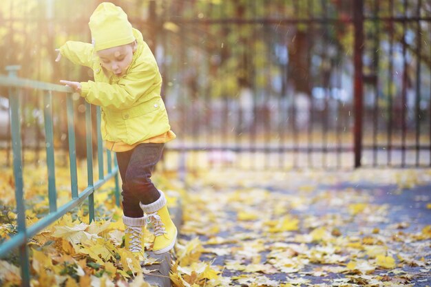 Children walk in the autumn park in the fall