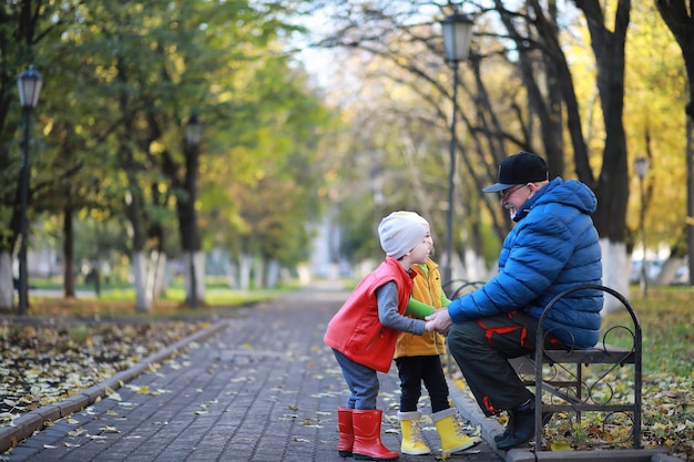 Children walk in the autumn park in the fall