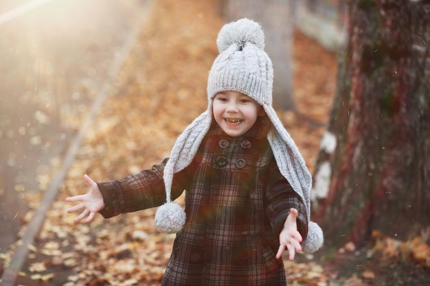 Children walk in the autumn park in the fall