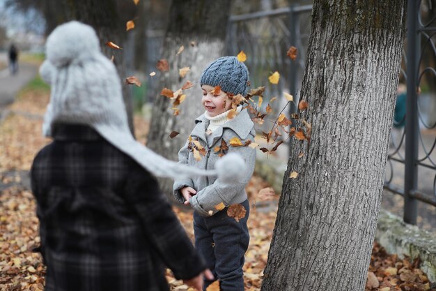 Children walk in the autumn park in the fallxA