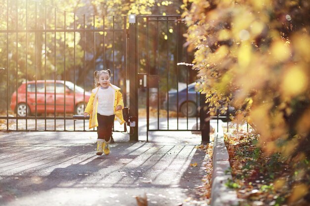 Children walk in the autumn park in the fallxA