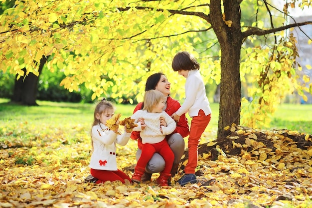 Children for a walk in the autumn park Leaf fall in the park Family Fall Happiness