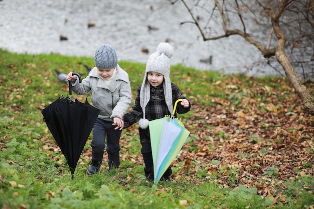 Children walk in the autumn park