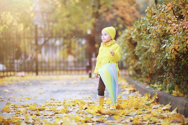 Children walk in the autumn park