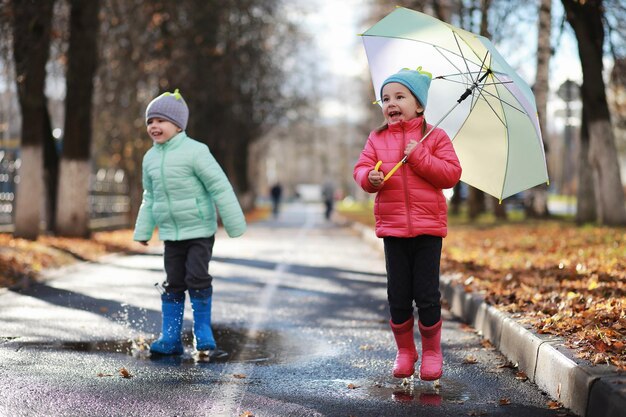 Children walk in the autumn park