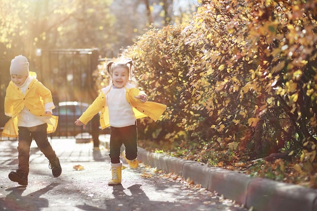 Children walk in the autumn park