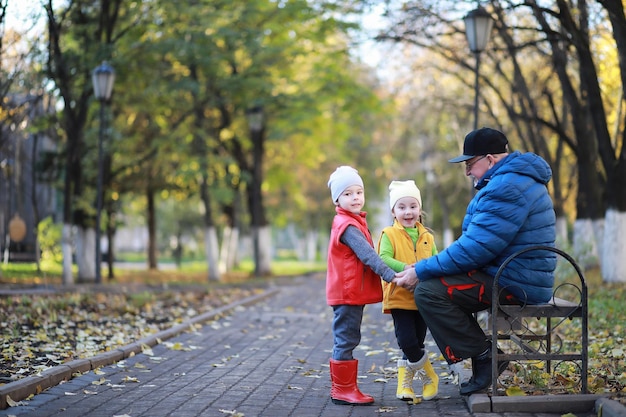 Children walk in the autumn park