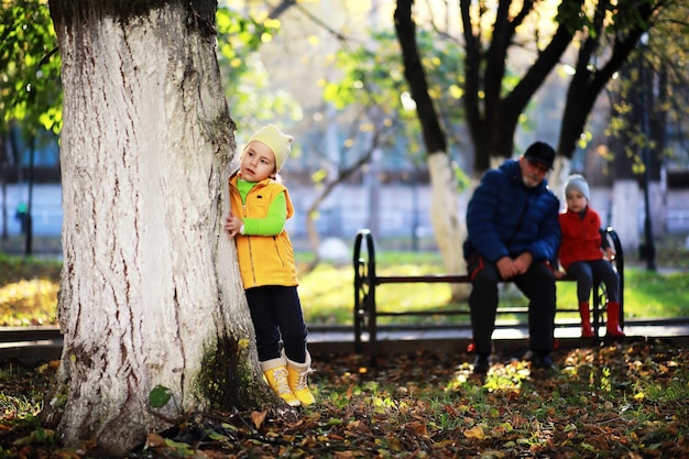 Children walk in the autumn park