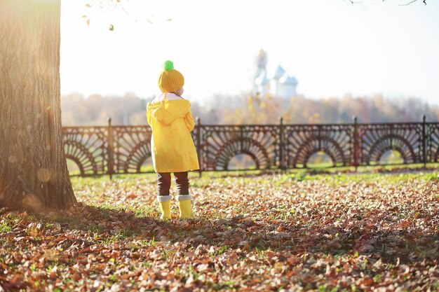 Children walk in the autumn park