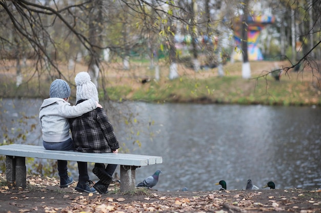 Children walk in the autumn park