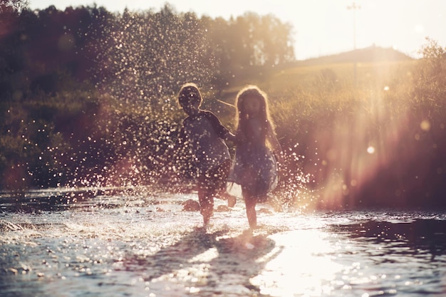 Children walk in the summer in nature Child on a sunny spring morning in park Traveling with children