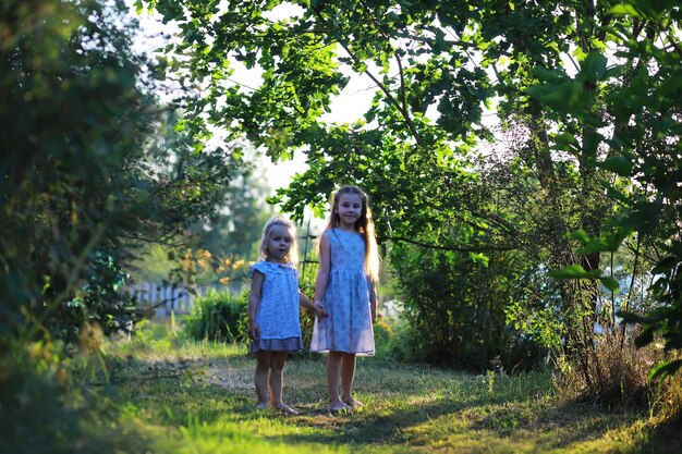 Children walk in the summer in nature Child on a sunny spring morning in the park Traveling with children