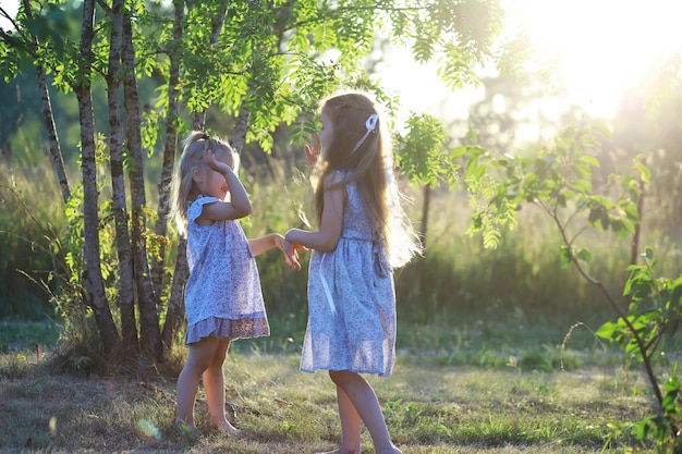 Children walk in the summer in nature Child on a sunny spring morning in the park Traveling with children