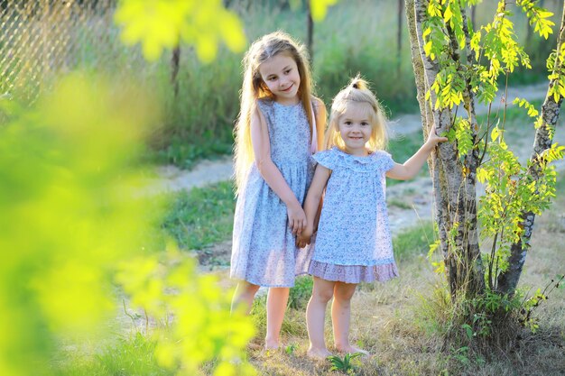 Children walk in the summer in nature Child on a sunny spring morning in the park Traveling with children