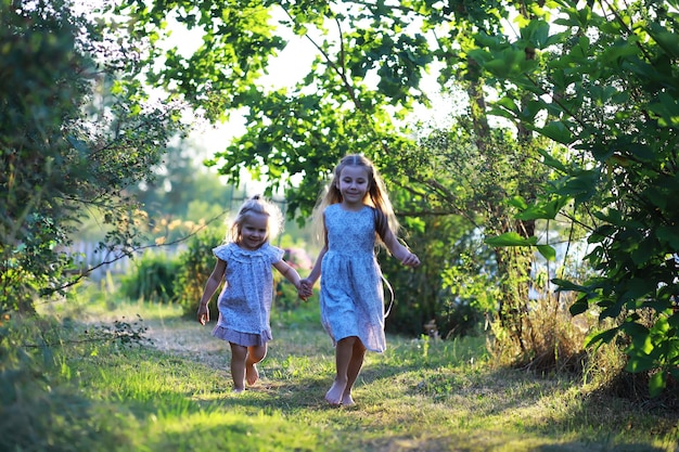 Children walk in the summer in nature Child on a sunny spring morning in the park Traveling with children