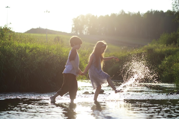 Children walk in the summer in nature Child on a sunny spring morning in the park Traveling with children