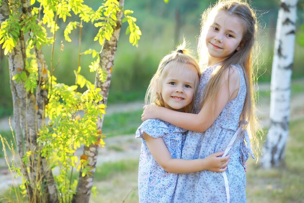 Children walk in the summer in nature Child on a sunny spring morning in the park Traveling with children