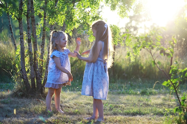 Children walk in the summer in nature Child on a sunny spring morning in the park Traveling with children