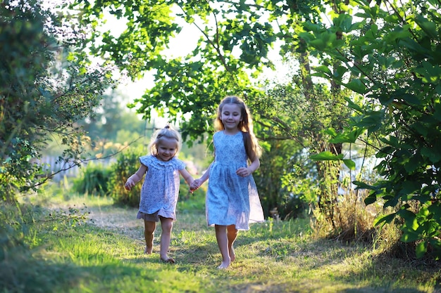 Children walk in the summer in nature Child on a sunny spring morning in the park Traveling with children